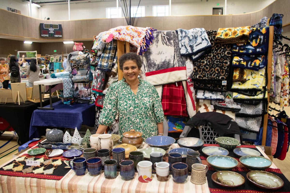 Sujata Harlarnkar poses with her booth of ceramic pieces for sale at the Spring Artisan Market at Fort Collins Senior Center April 13.