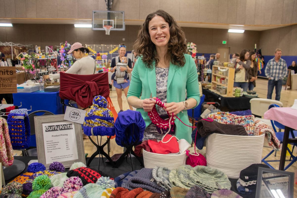 Michelle, owner of Curly Knits, poses with her booth during the Spring Artisan Market at Fort Collins Senior Center April 13.