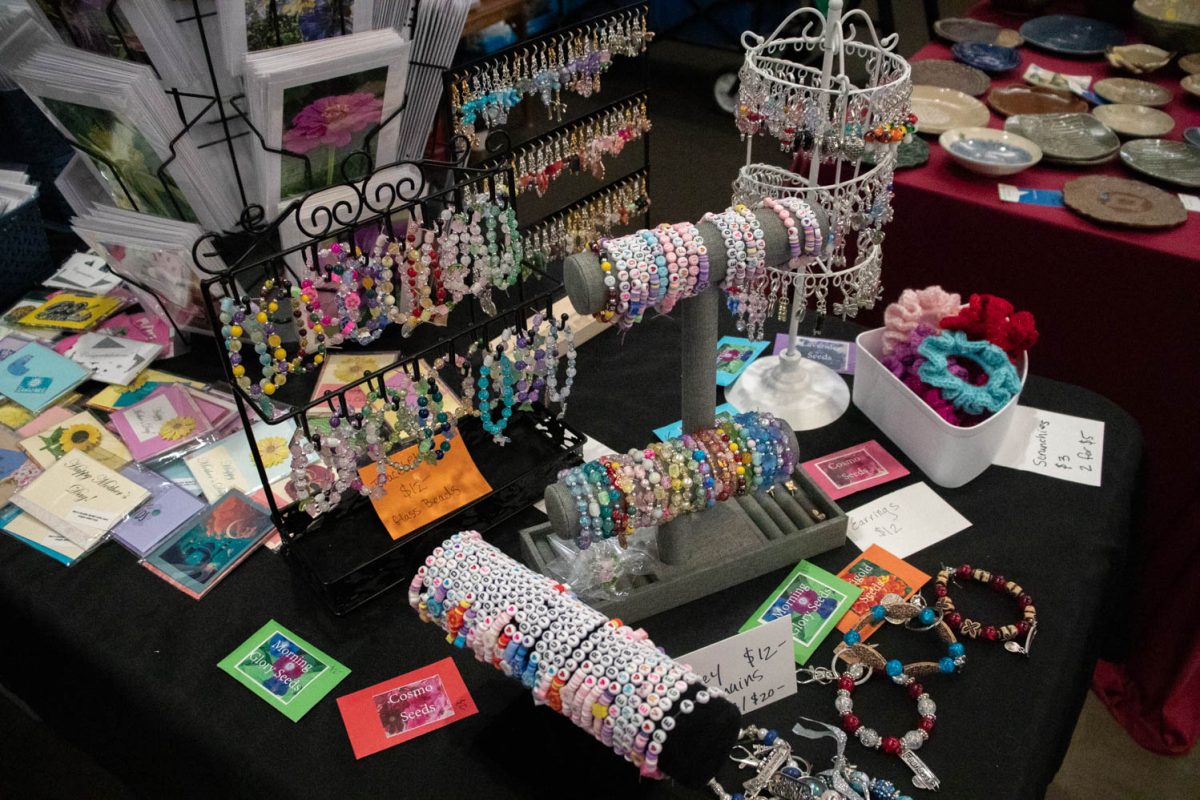 Taylor Swift bracelets, keychains, cards and other goods from the shop 'Lovely Flower Designs' sit on display during the Spring Artisan Market at Fort Collins Senior Center April 13.