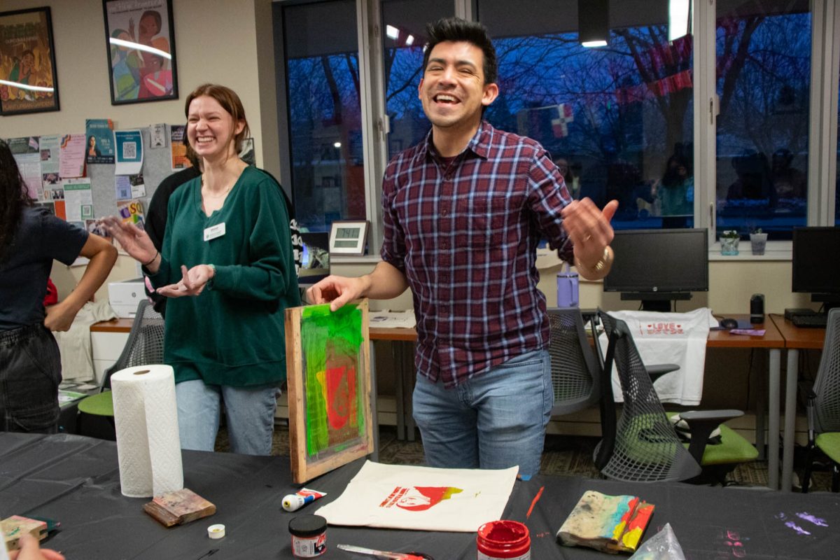 Aaron Escobedo Garmon, interim director of El Centro, smiles after completing his screen printed tote bag during the Love Women of Color: Celebrating Empowerment Through Art screen printing workshop April 18.