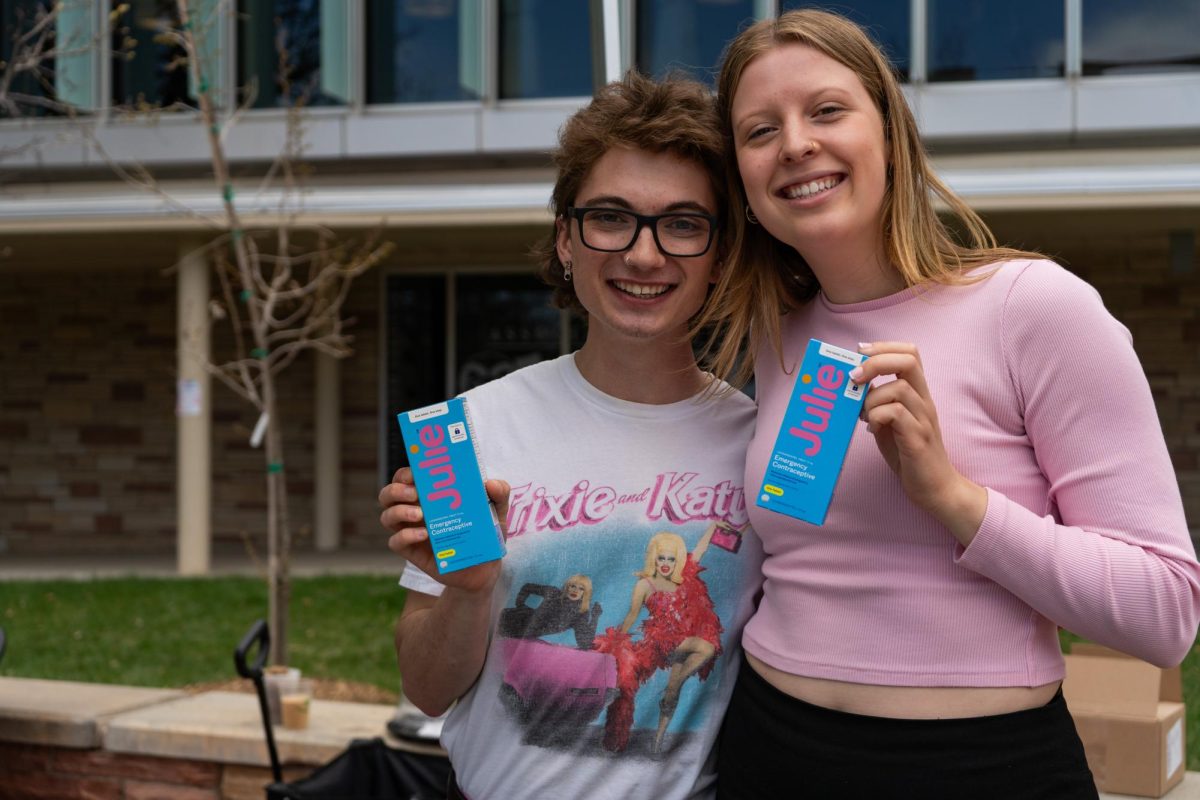 Associated Students of Colorado State University Vice President Alex Silverhart and ASCSU intern Lauren Johnson pose with free emergency contraceptives on The Plaza April 24. 