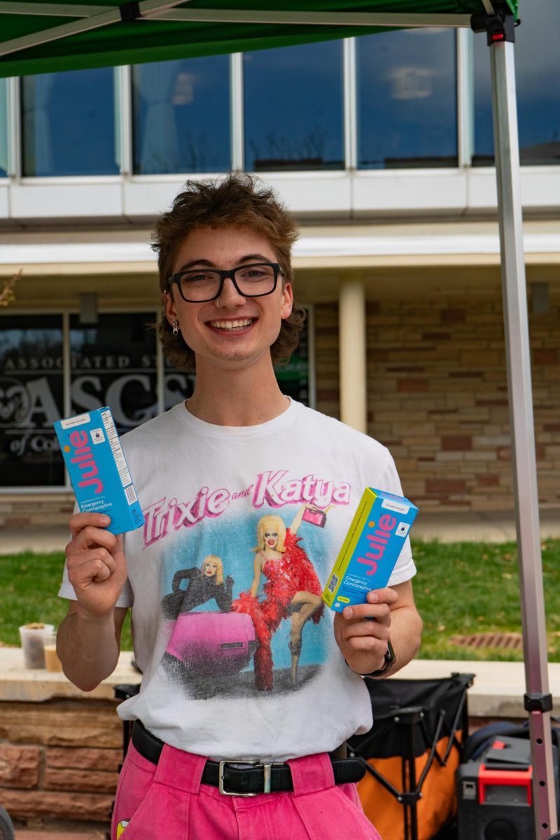 Associate Students of Colorado State University Vice President Alex Silverhart poses with two of the free emergency contraceptives being handed out on the Lory Student Center Plaza Wednesday, April 24. 