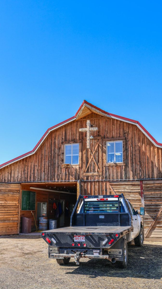 Showcasing a large cross strung with lights, the Harvest Farms agricultural barn serves as a workplace and an enclosure for animals March 18. 