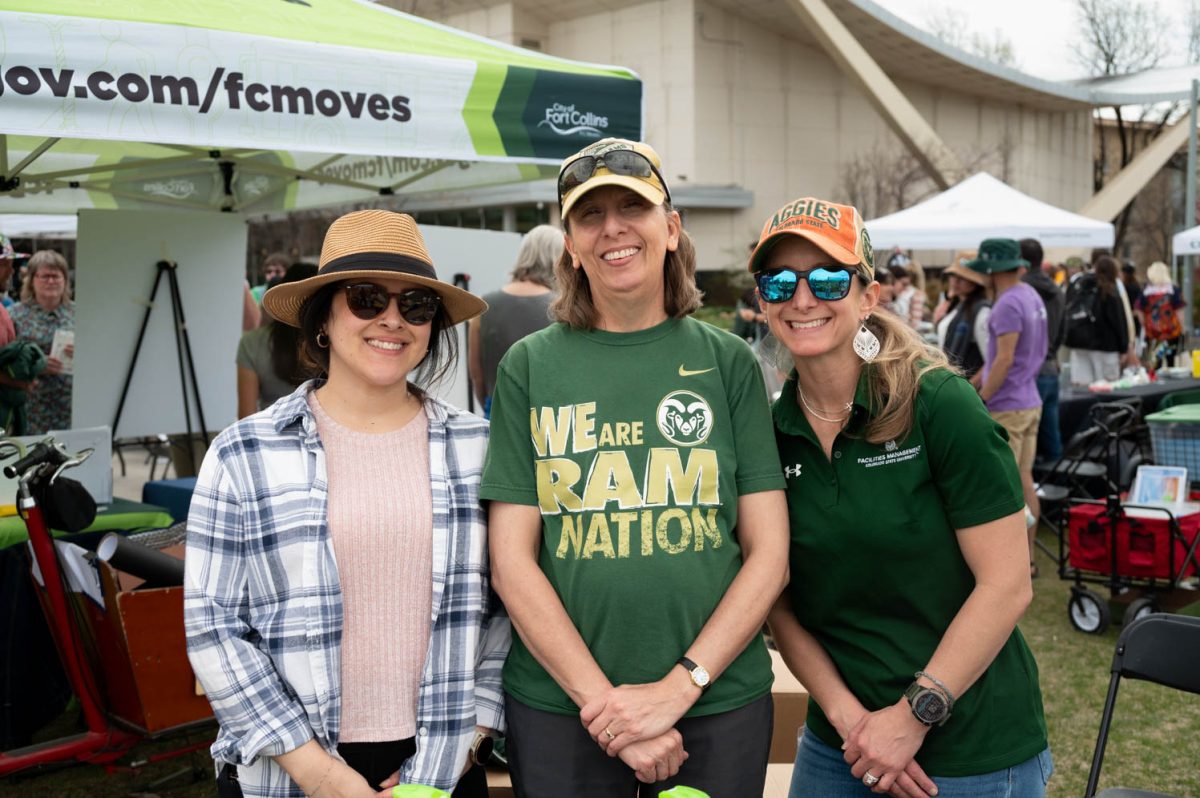 Jasmine Hatten (L), Heidi Mechtenberch (C), and Brit McCullar (R) pose at their Clean Water station hoping to educate the public on how impactful pollution is to our waters. Colorado State University Earth Day Festival April 22 