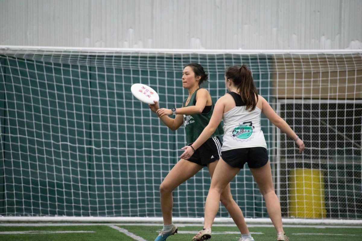 Cice Kim, a captain of the Colorado State University womens and nonbinary  ultimate frisbee team Hells Belles, throws a frisbee during an indoor practice Feb. 14.