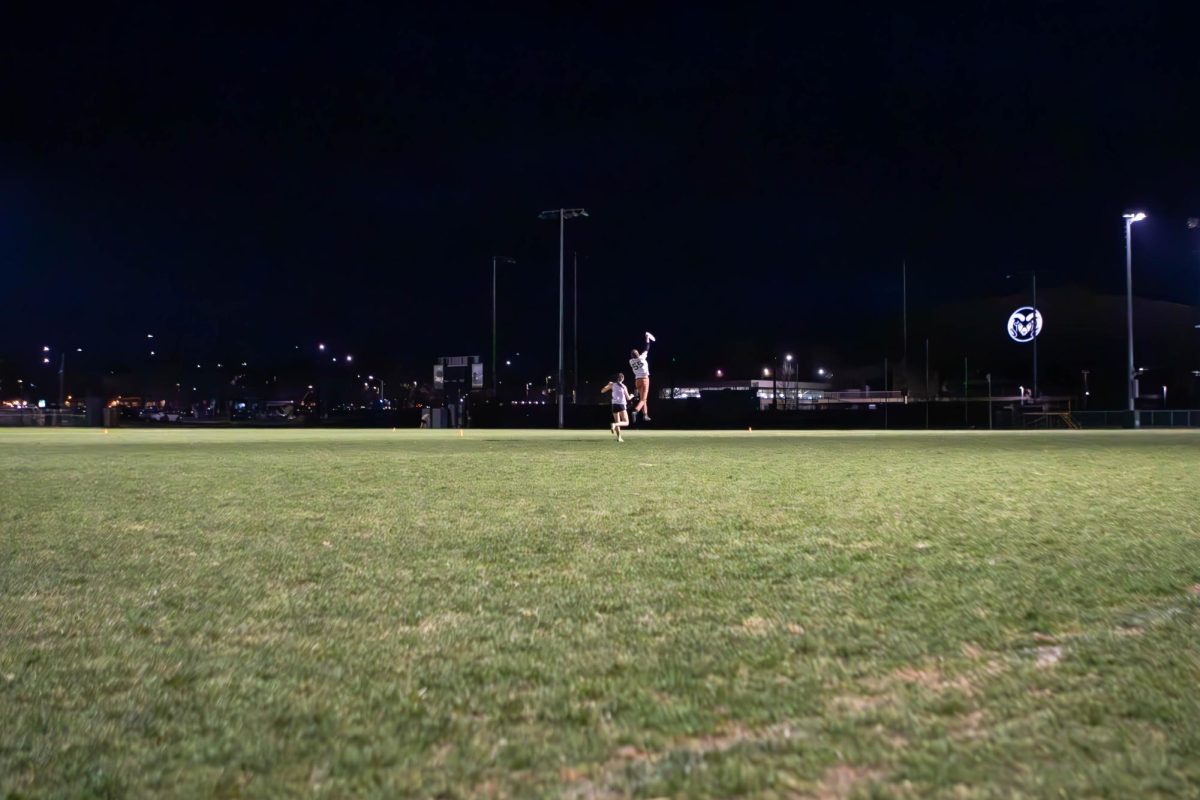A member of the Colorado State University Womxn's Ultimate frisbee club team "Hell's Belles" jumps to catch the frisbee at their practice. Apr. 4.
