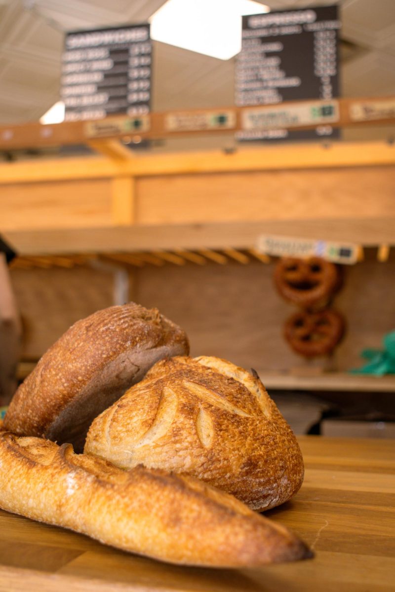 The Bread Chic, a Fort Collins local bakery offers freshly baked pastries and breads Monday through Sunday. A Rye loaf, Rosemary sourdough loaf, and Baguette are shown stacked on top of one another. Apr. 8.