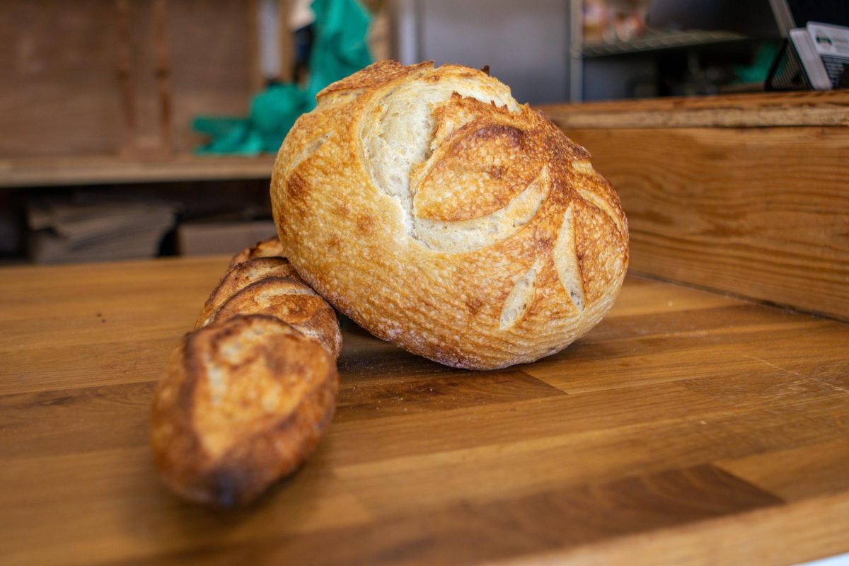 A freshly baked Rosemary sourdough loaf and baguette are shown on a counter at The Bread Chic. Apr. 8.