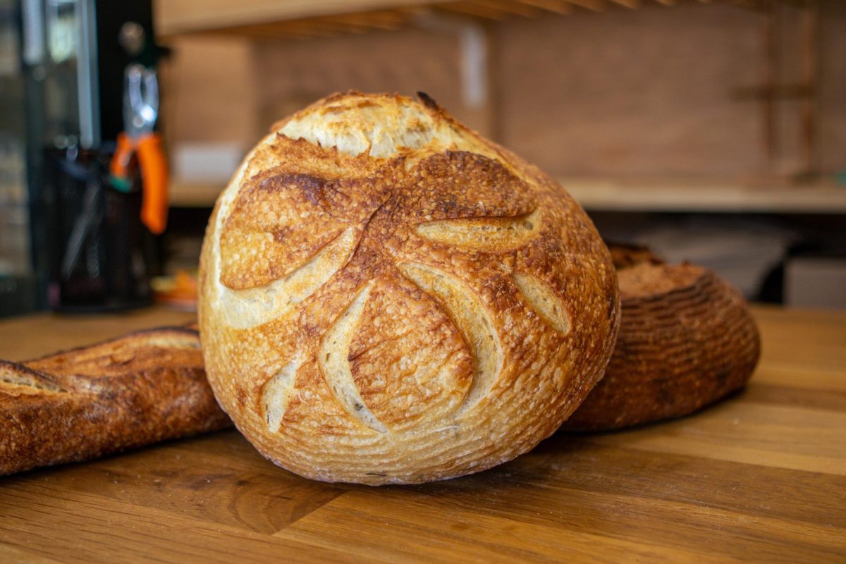A freshly baked Rosemary sourdough loaf and baguette are shown on a counter at The Bread Chic. Apr. 8.
