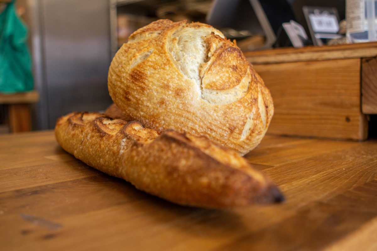 A freshly baked Rosemary sourdough loaf and baguette are shown on a counter at The Bread Chic. Apr. 8.