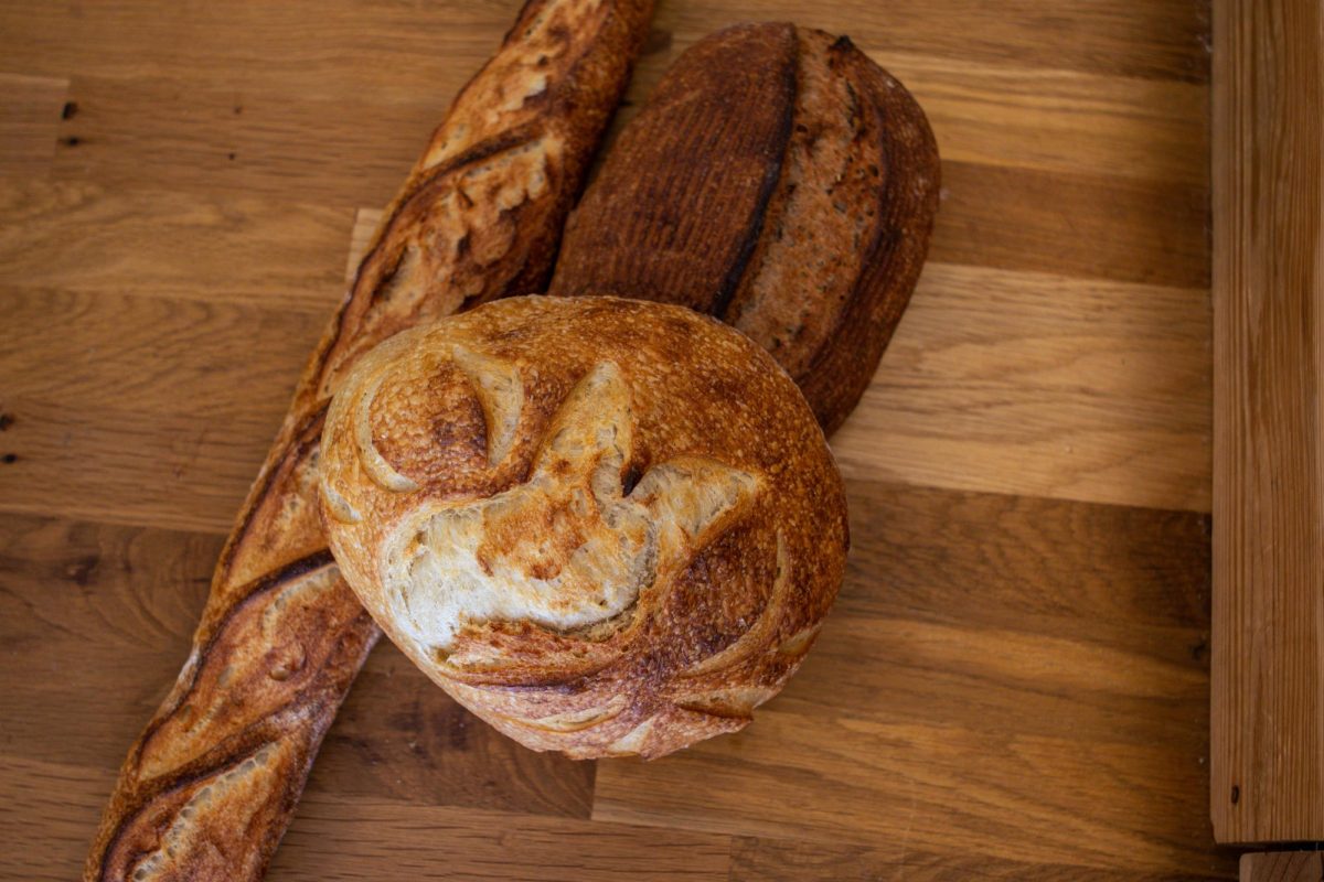 The Bread Chic, a Fort Collins local bakery offers freshly baked pastries and breads Monday through Sunday. A Rye loaf, Rosemary sourdough loaf, and Baguette are shown stacked on top of one another. Apr. 8.