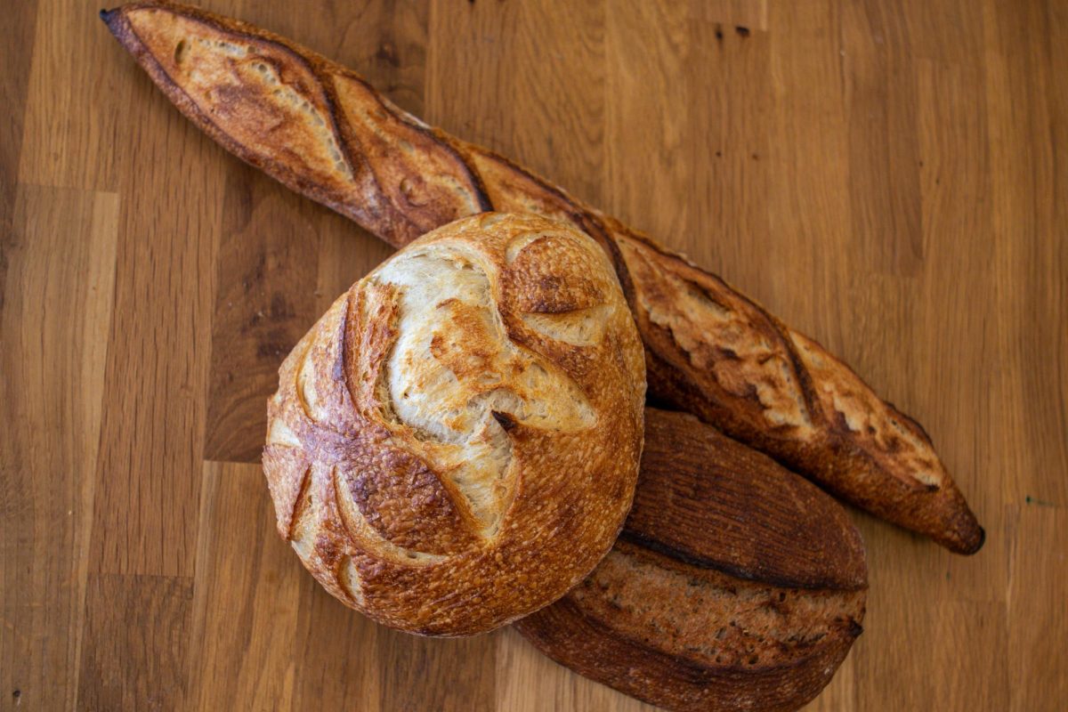 The Bread Chic, a Fort Collins local bakery offers freshly baked pastries and breads Monday through Sunday. A Rye loaf, Rosemary sourdough loaf, and Baguette are shown stacked on top of one another. Apr. 8.