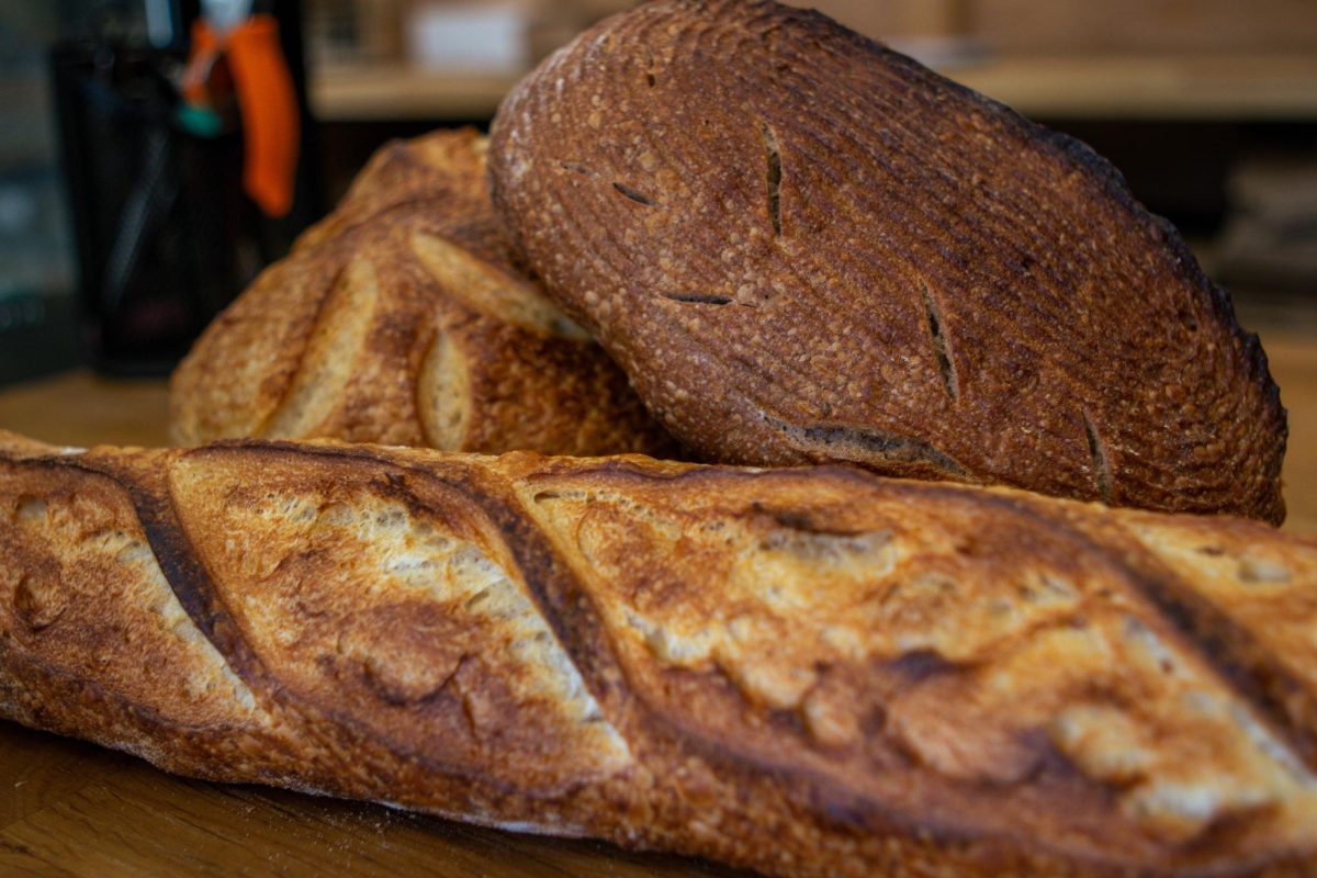 The Bread Chic, a Fort Collins local bakery offers freshly baked pastries and breads Monday through Sunday. A Rye loaf, Rosemary sourdough loaf, and Baguette are shown stacked on top of one another. Apr. 8.