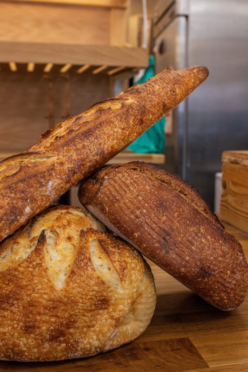 The Bread Chic, a Fort Collins local bakery offers freshly baked pastries and breads Monday through Sunday. A Rye loaf, Rosemary sourdough loaf, and Baguette are shown stacked on top of one another. Apr. 8.