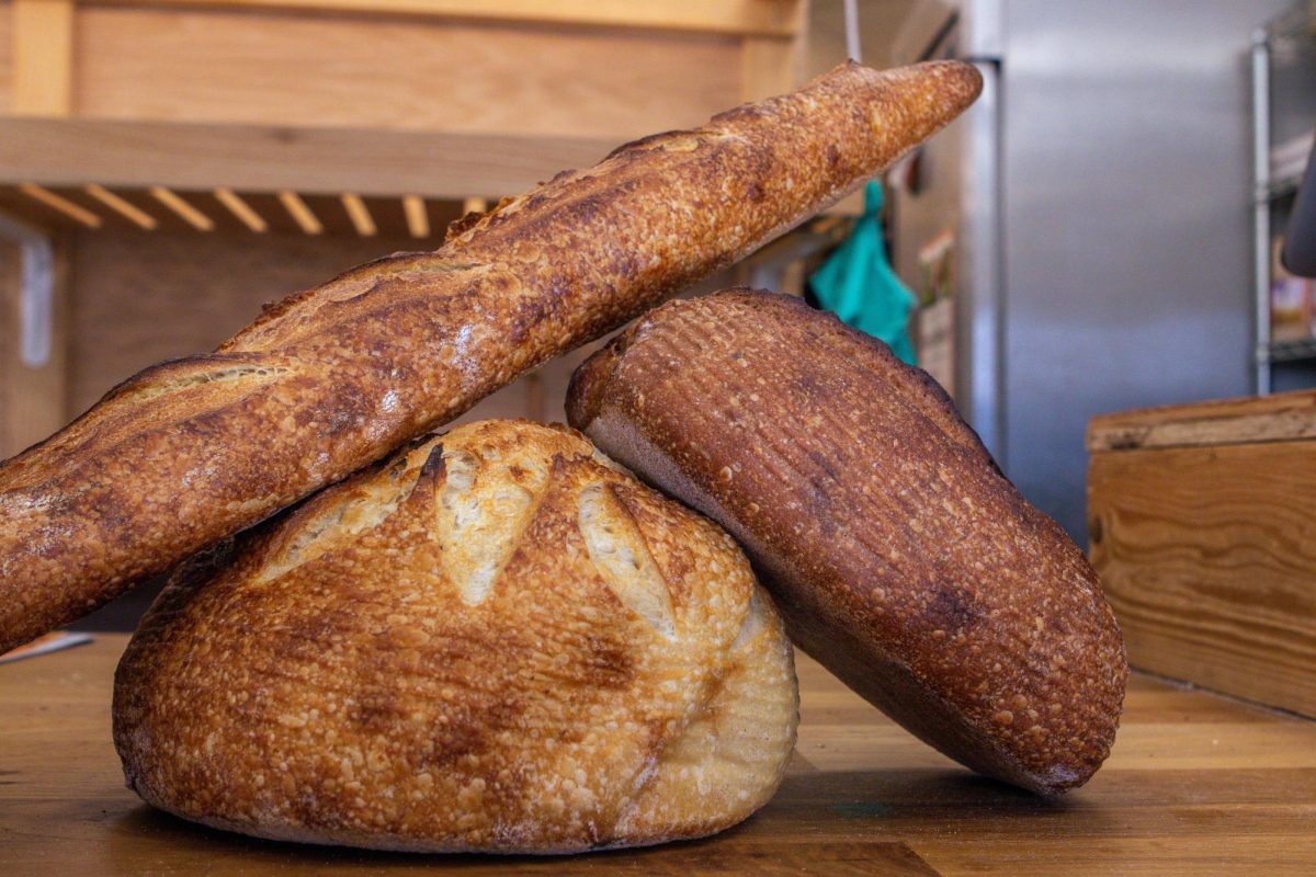 The Bread Chic, a Fort Collins local bakery offers freshly baked pastries and breads Monday through Sunday. A Rye loaf, Rosemary sourdough loaf, and Baguette are shown stacked on top of one another. Apr. 8.