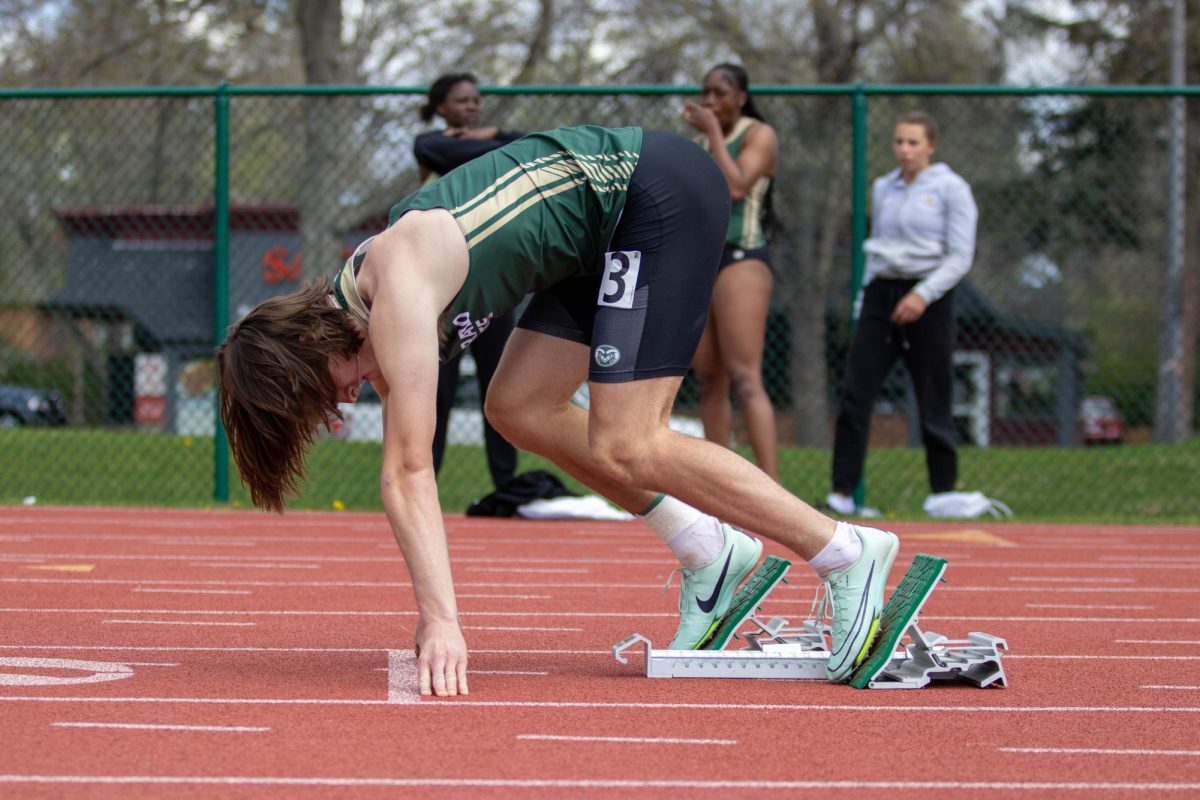 Tyler Bennet sits ready to sprint in the mens 200 meter dash at the Doug Max invitational. Apr. 28.