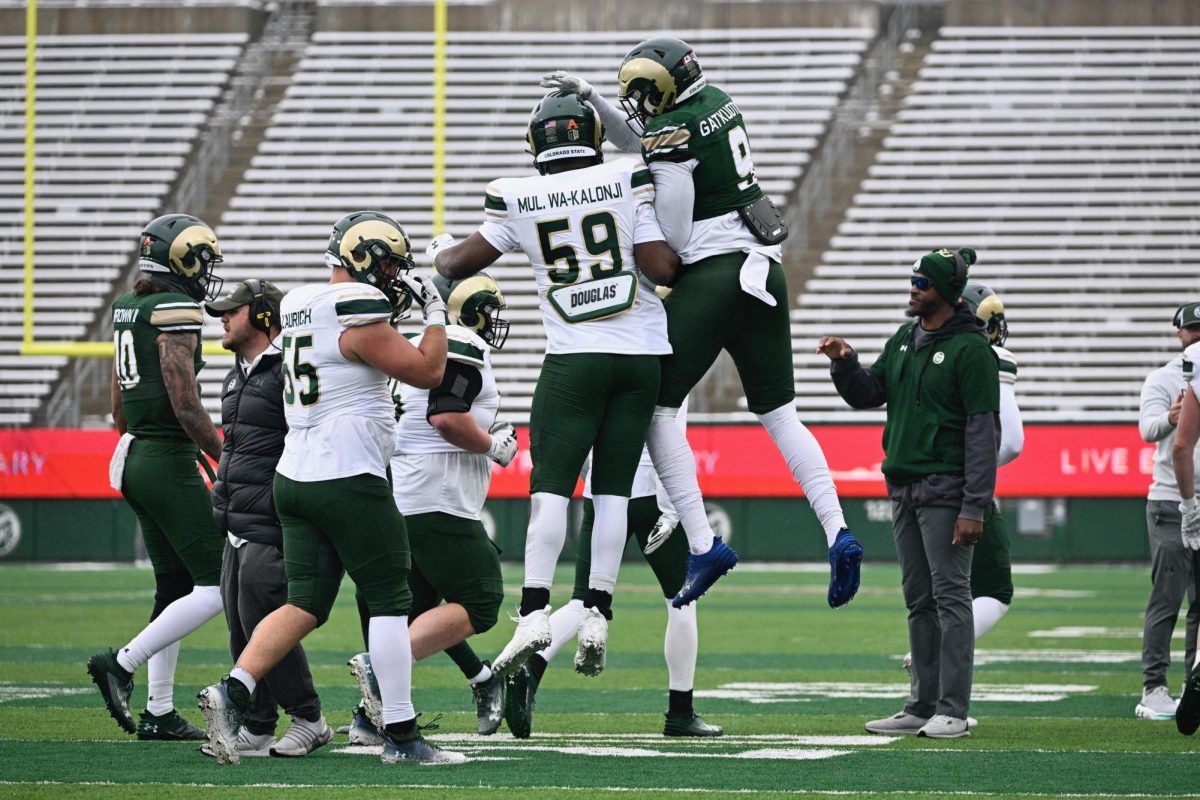 Nuer Gatkuoth and Mulumba Wa-Kalonji celebrate turnover during the Colorado State spring football game at Canvas Stadium, April 20. 