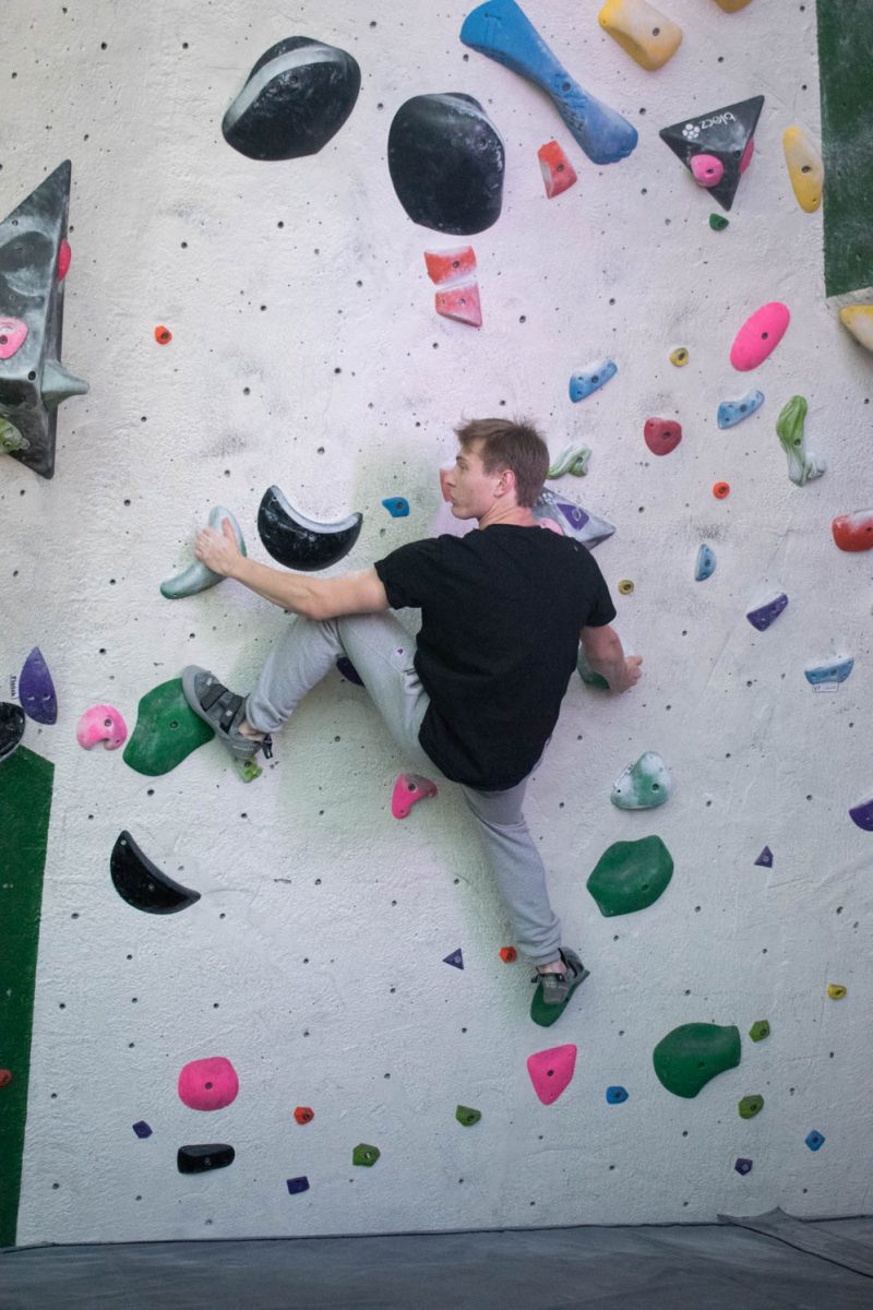 Colorado State University student Benjamin Haddad climbs at the CSU Student Recreation Center climbing wall on April 2, 2024.