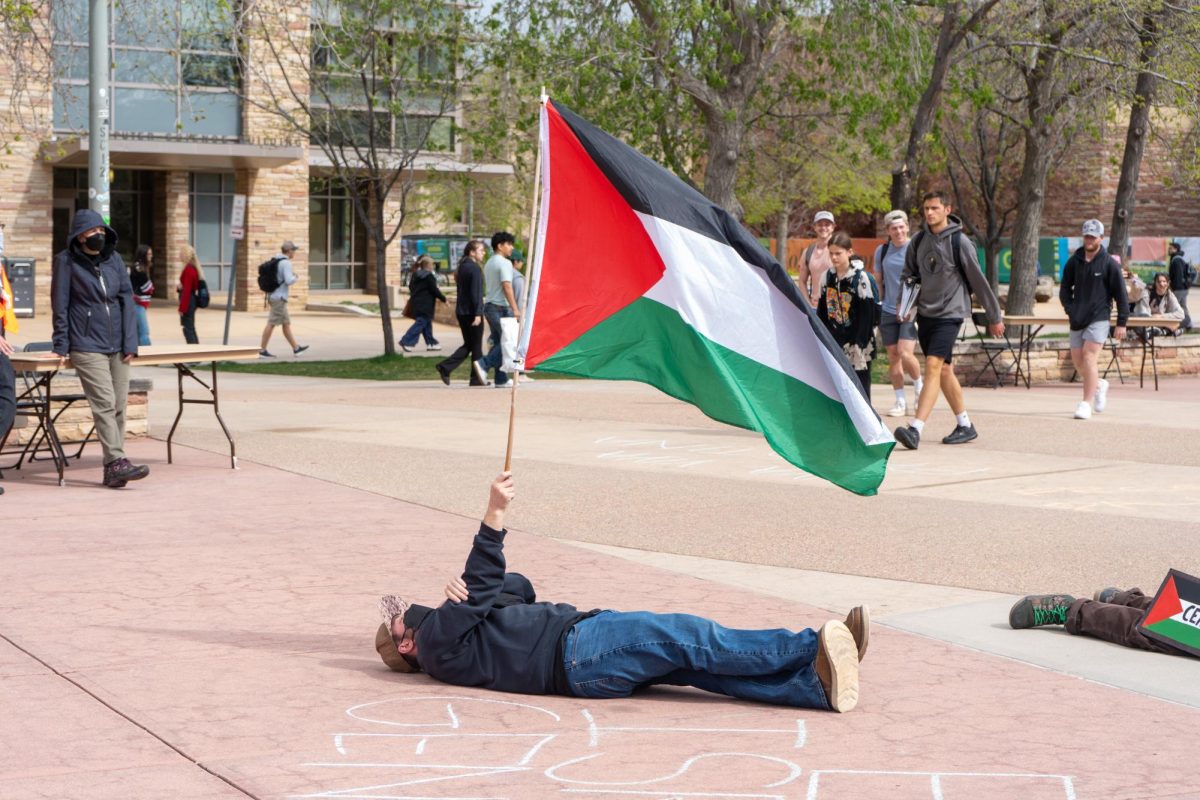 A protestor lays on the ground outside the Lory Student Center Plaza during a Students for Justice in Palestine protest on May 1. The protest included a die-in, a time where protestors were encouraged to lay in silence on the ground to demonstrate in support of Palestine.  