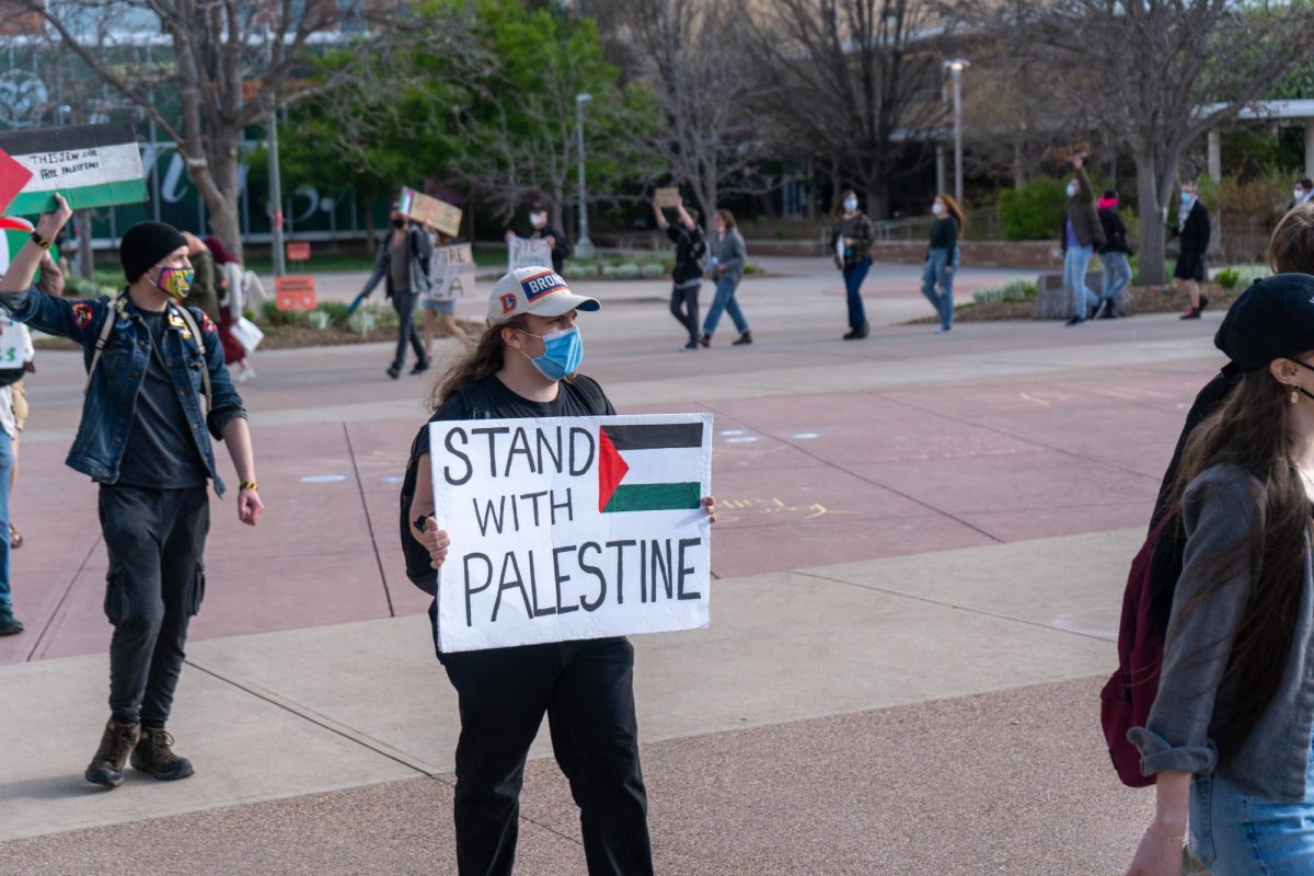 Protestors march with signs declaring Stand with Palestine outside the Lory Student Center Plaza during a Students for Justice in Palestine protest on May 1. The protest included chanting and marching in support of Palestine  The protest included chanting and marching in support of Palestinians and demanded Colorado State University calls for a ceasefire in Gaza.