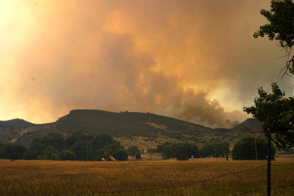 Smoke and from the Alexander Mountain Fire can be seen over the ridge in the residential area just east of the fire off of U.S. Highway 34 July 30. 