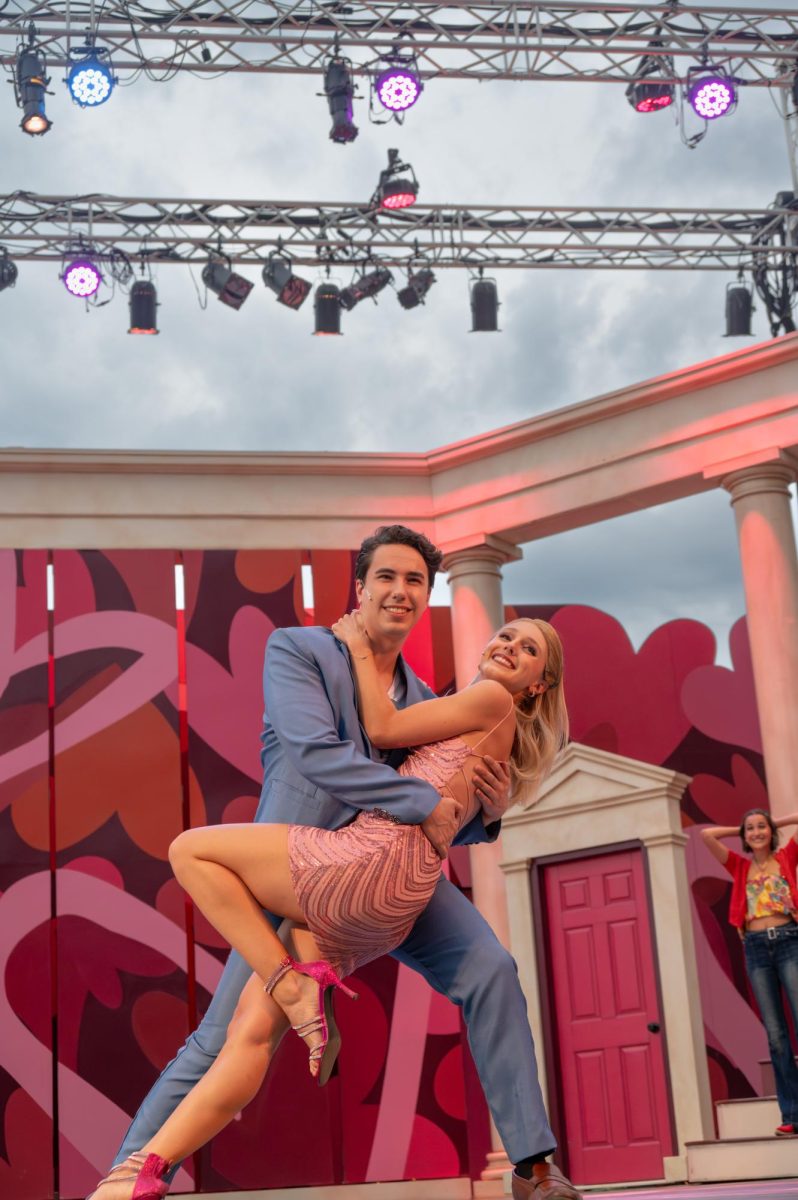 Peyton Hines (Elle Woods) and Andy Cico (Warner) pose for a button after "Omigod You Guys!" during Legally Blonde which is this years production on the Wilcox Main stage in Portsmouth, New Hampshire. Every year a performance is held here and this year is extra special, it is Prescott Park's 50 anniversary of performances. Actors and Actresses from all around the area spend all of the spring and some of the summer perfecting choreography and scenes to bring together a performance for the general public. The Performing Arts Festival (PFA) program believes firmly that no matter your financial standing, the public should be welcome to see the show. This is why there is no set ticket price, the price you pay is simply a recommended donation. The public can also come in and reserve blankets and lawn chairs for viewing as the stage is outside and the seating arrangements are general admission, or Bring your own chair/blanket. the show concludes this Sunday August 11, 2024. 