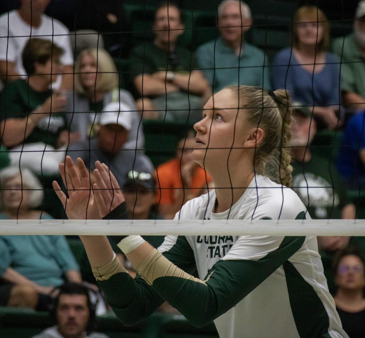 Karina Leber (42) gets ready to jump up to block an attacking spike from opponent Creighton University on August 24. 