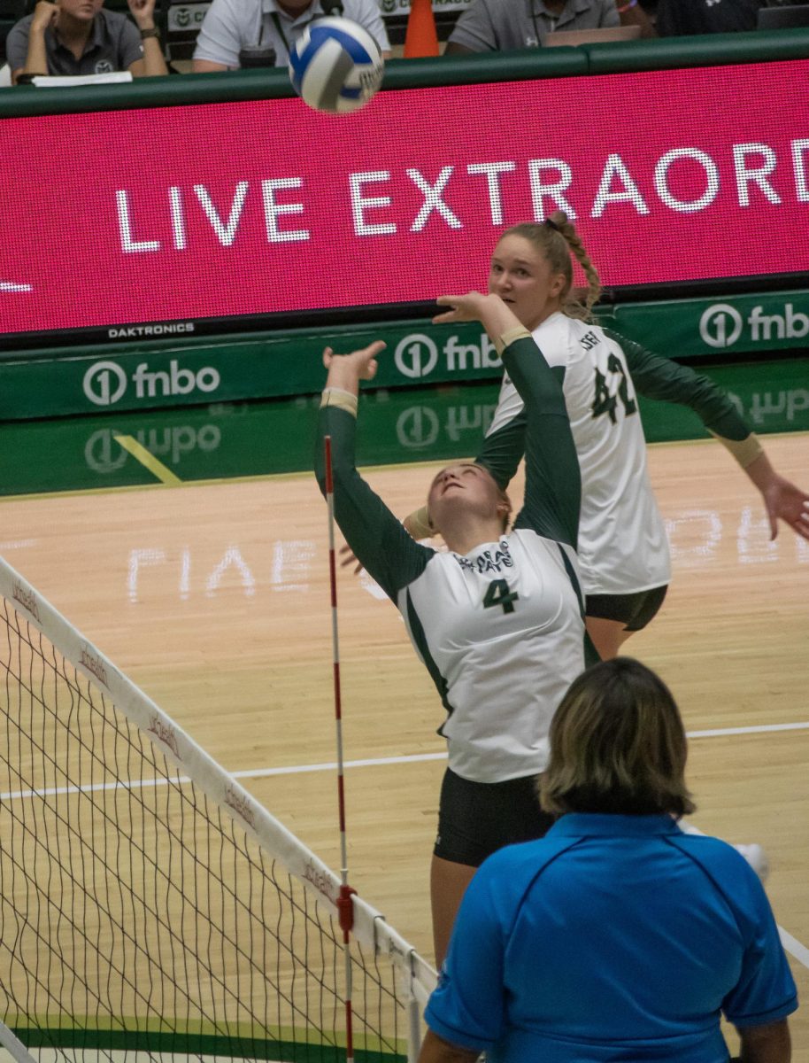 Emery Herman (4) sets the ball to Karina Leber (42) to score a point for the Colorado State University Women's Volleyball Team vs Creighton University on August 24. 