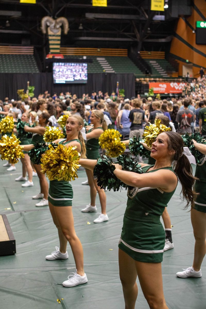 Colorado State University cheerleaders dance in sync at Convocation in Moby Arena Aug. 16. Convocation marks the start of new students' academic journey at CSU and features a guest speaker and performances from the pep band and the cheer team. 