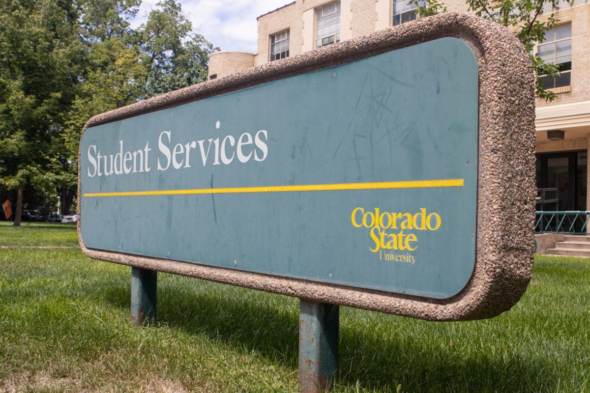 A green Colorado State University building identification sign with Student Services printed on it