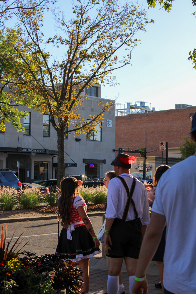 Fort Collins locals walk to Brothers Bar and Grill during the Oktoberfest Pub Crawl Sept. 28.