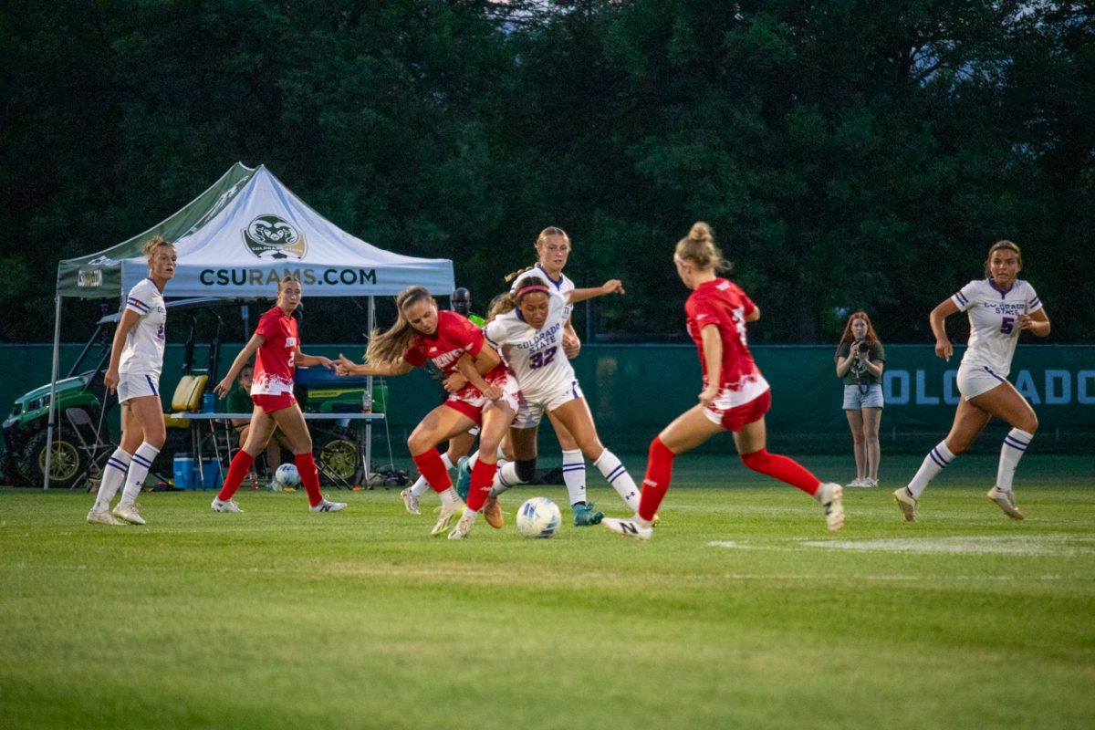 Two soccer players fight over the ball.