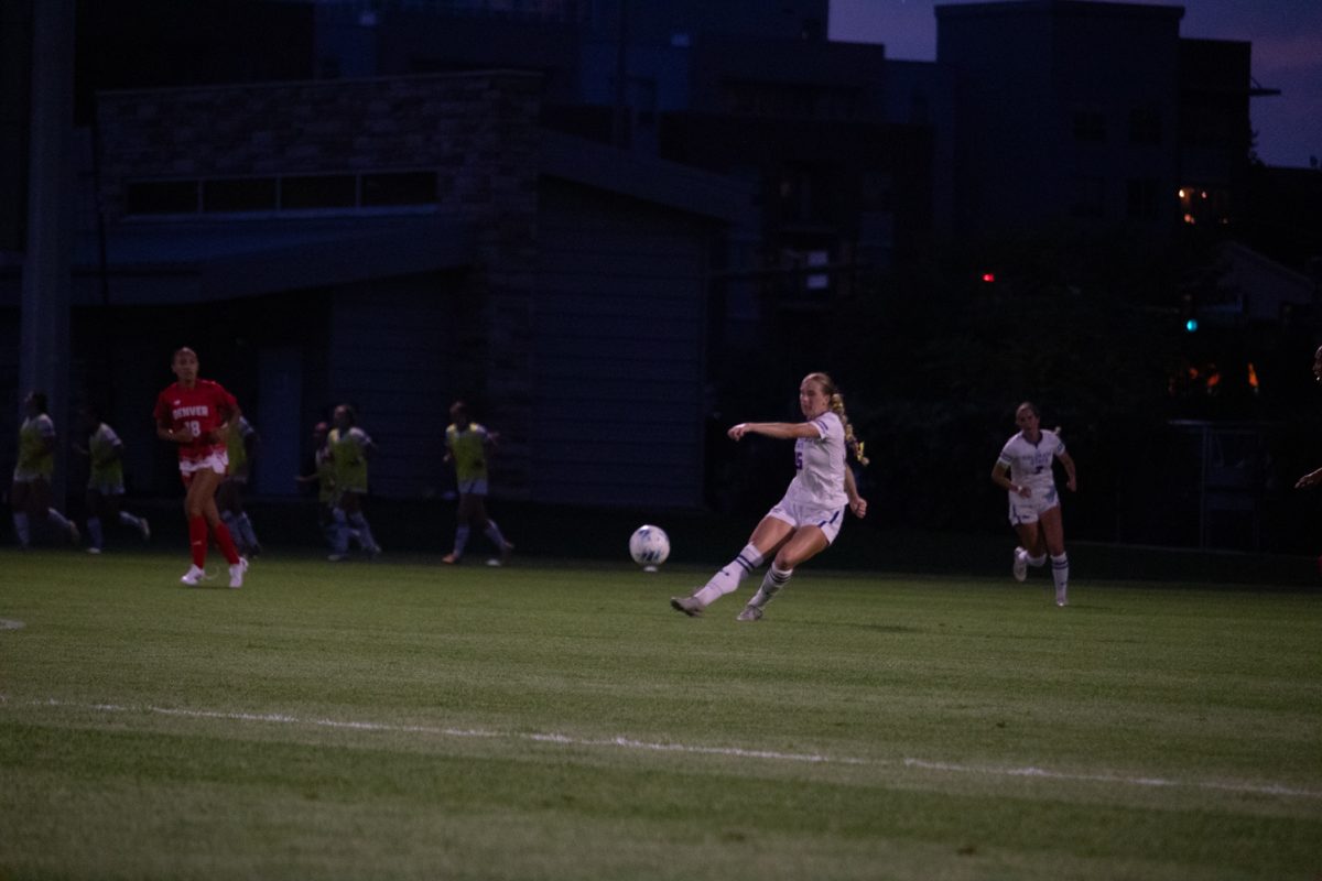A soccer player kicks a ball.