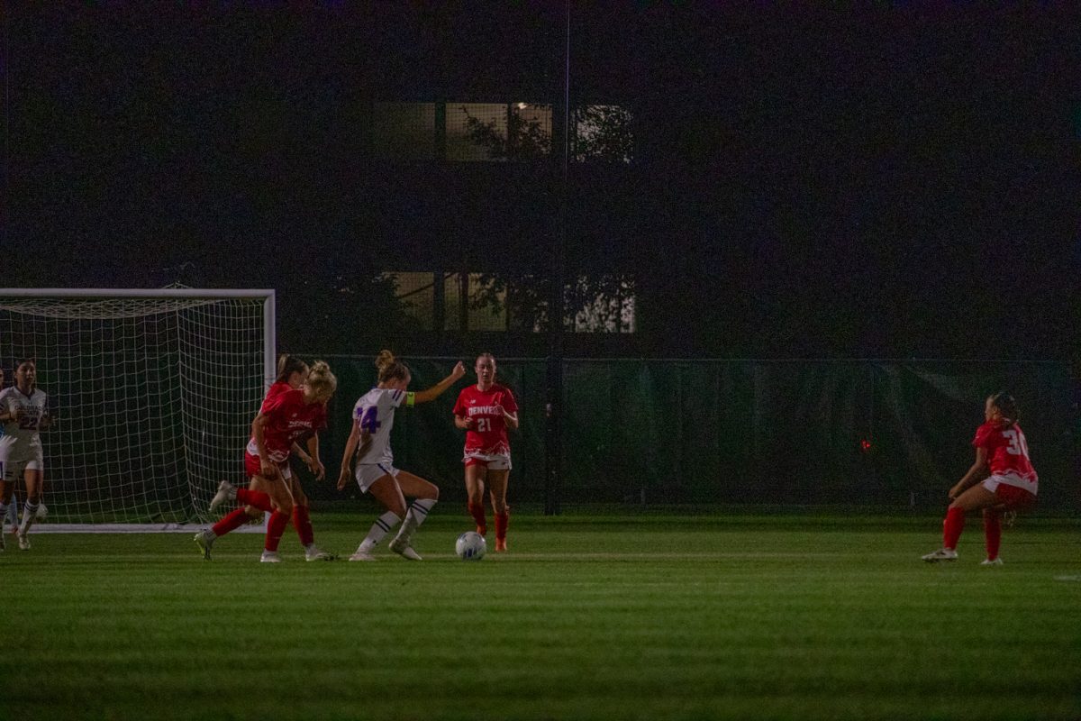 A soccer player tries to kick the ball.