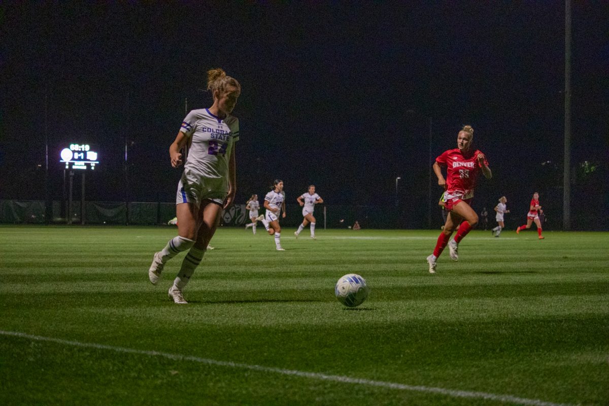 A soccer player is kicking a ball.