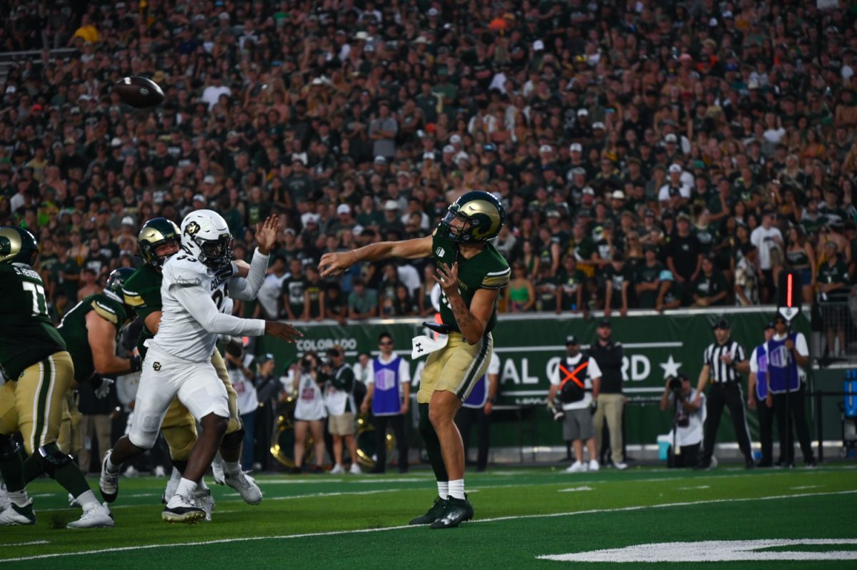 a player in green and gold throws a ball