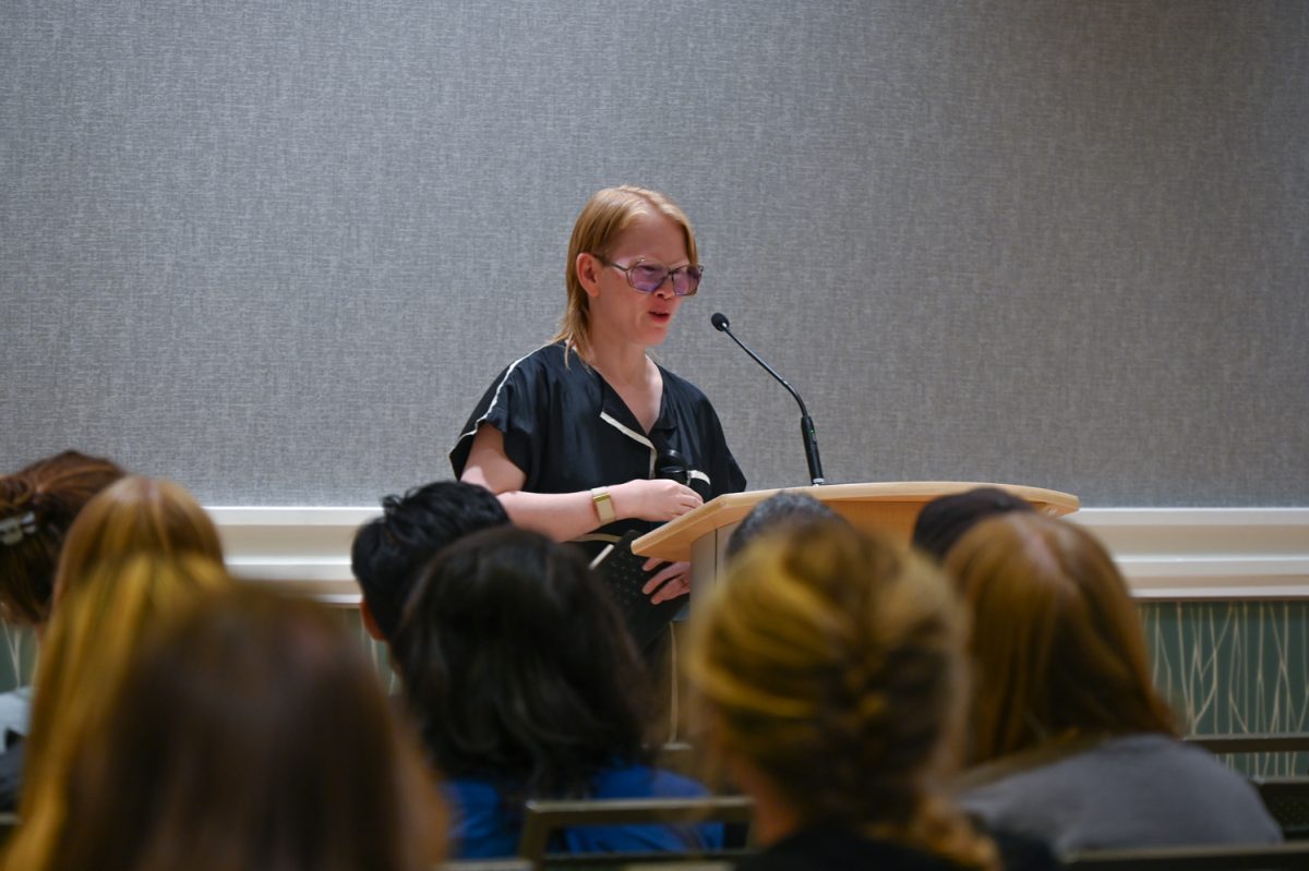 A woman in front of a podium with glasses on