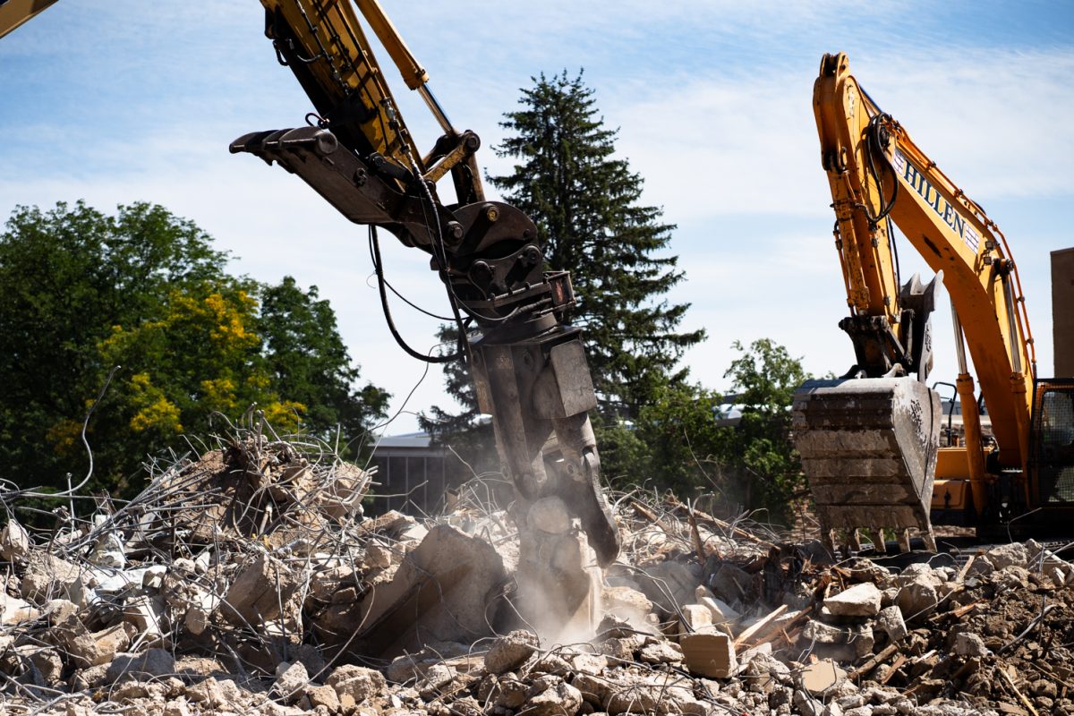 A material handling excavator moves rubble from a pile of debris during Clark B demolition Sept. 12. Clouds of dust get kicked up on a daily basis due to Clark renovations.