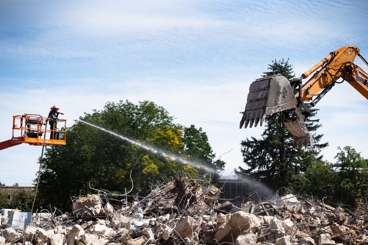 A construction worker uses a fire hose to tamp down dust rising from a pile of rubble during Clark demolition Sept. 12. an excavator remove rubble from a pile during Clark demolition Sept. 12. Demolition of Clark B progresses Sept. 12. The renovations, set to be complete by 2027, have seen the removal of the B wing of Clark. 