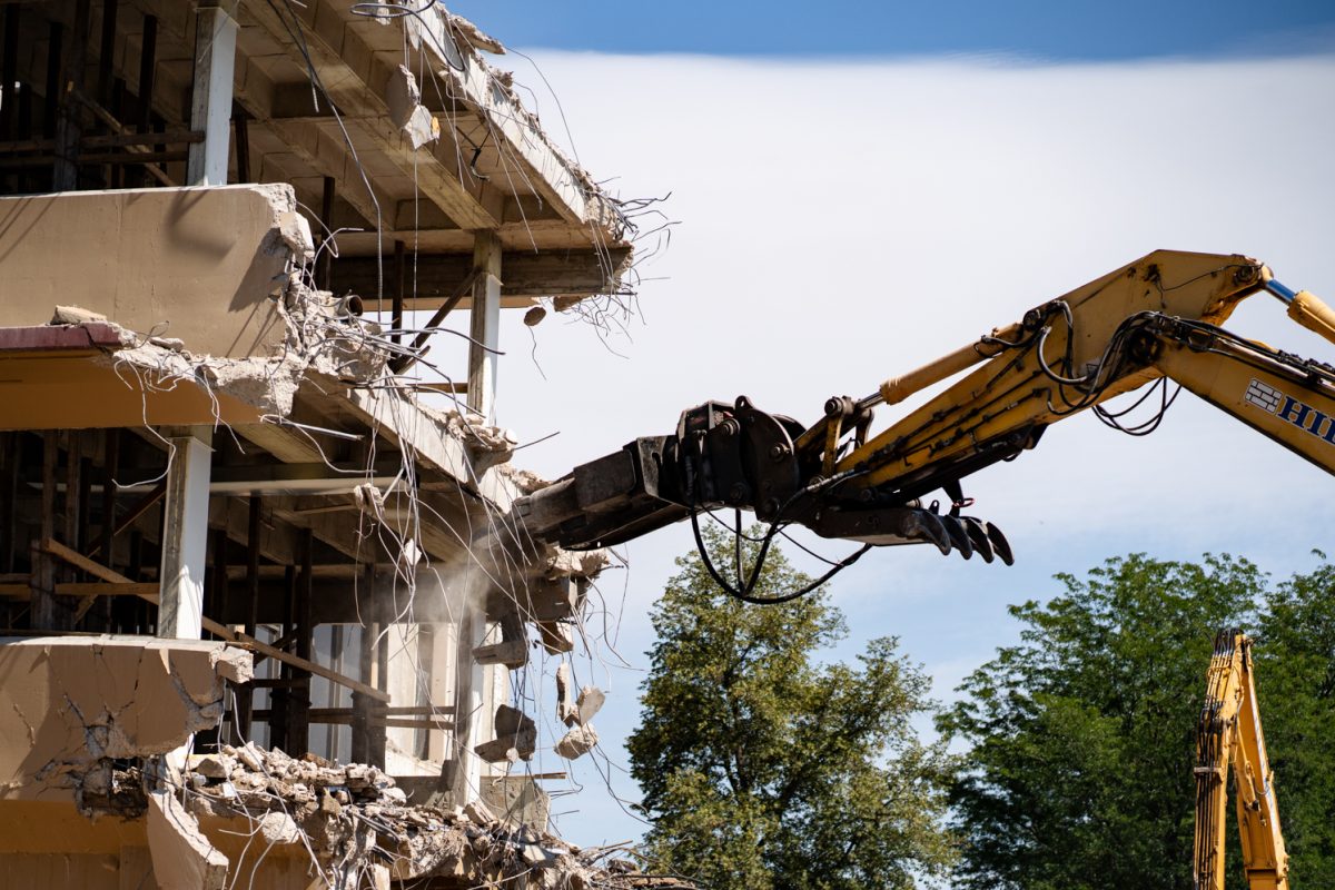 A material-handling excavator removes debris from the B wing of the Andrew G. Clark Building during demolition Sept. 12. The renovations are set to be complete by 2027.
