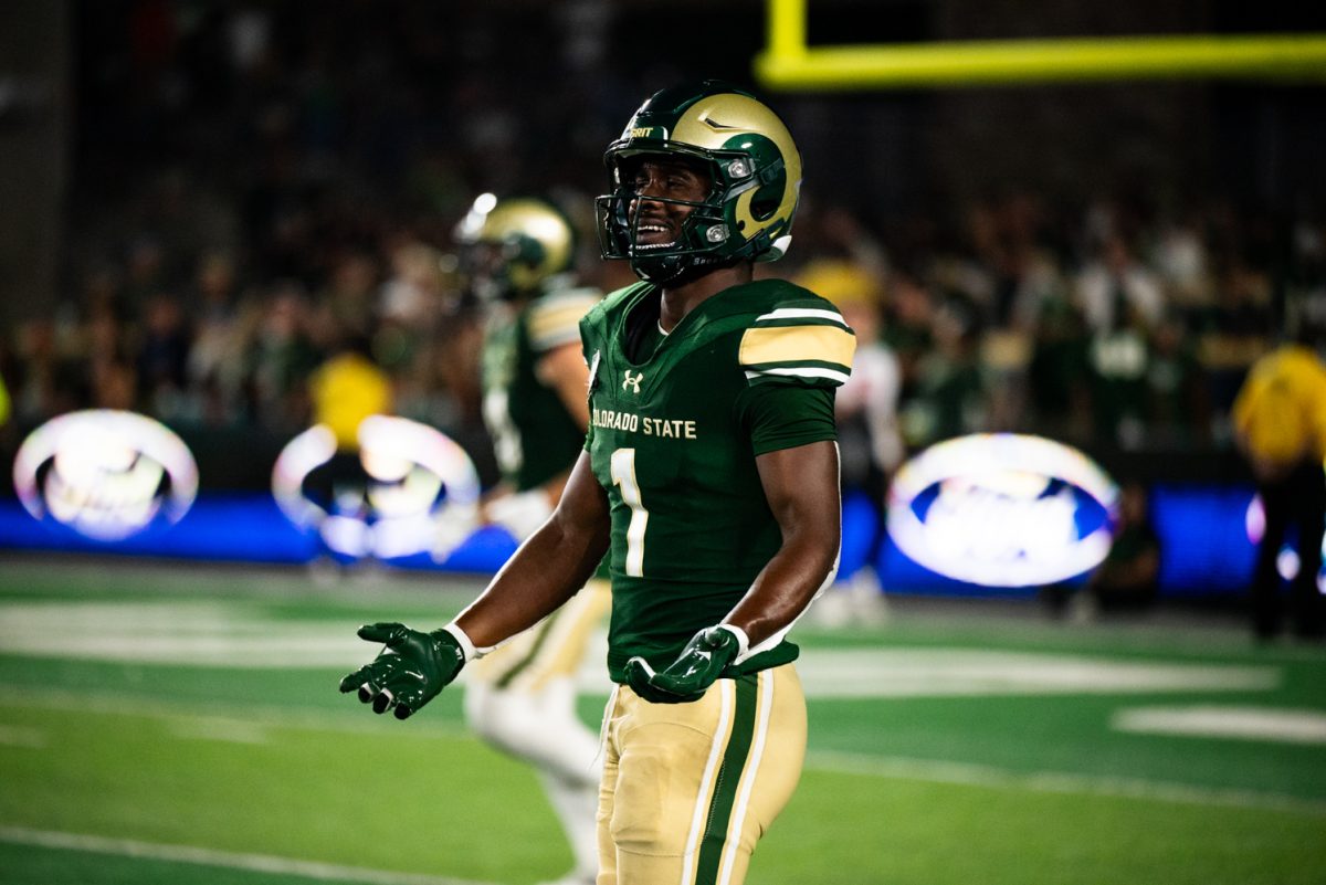 A Colorado State football player holds out his hands.