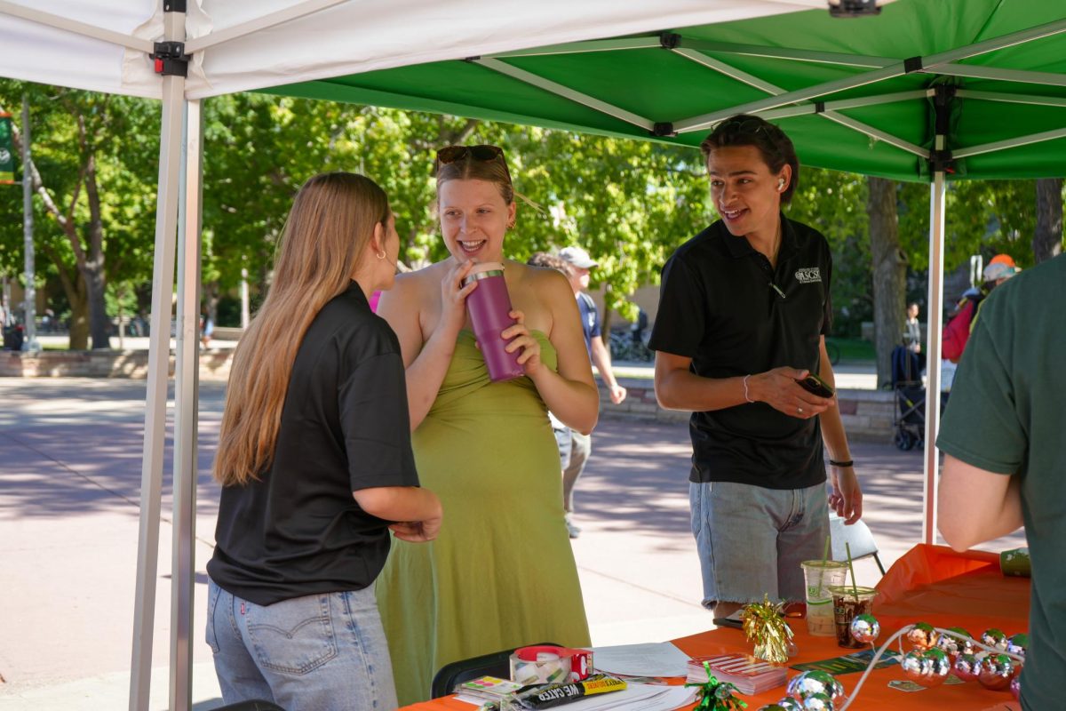 Associated Students of Colorado State University Deputy Director of Basic Needs Lauren Johnson laughs with Director of Governmental Affairs Ava Wilkins and Director of Public Relations Joseph Godshall at ASCSU's Wellness Wonderland. The event was organized by the Department of Basic Needs and aimed to provide health and wellness resources for students. 