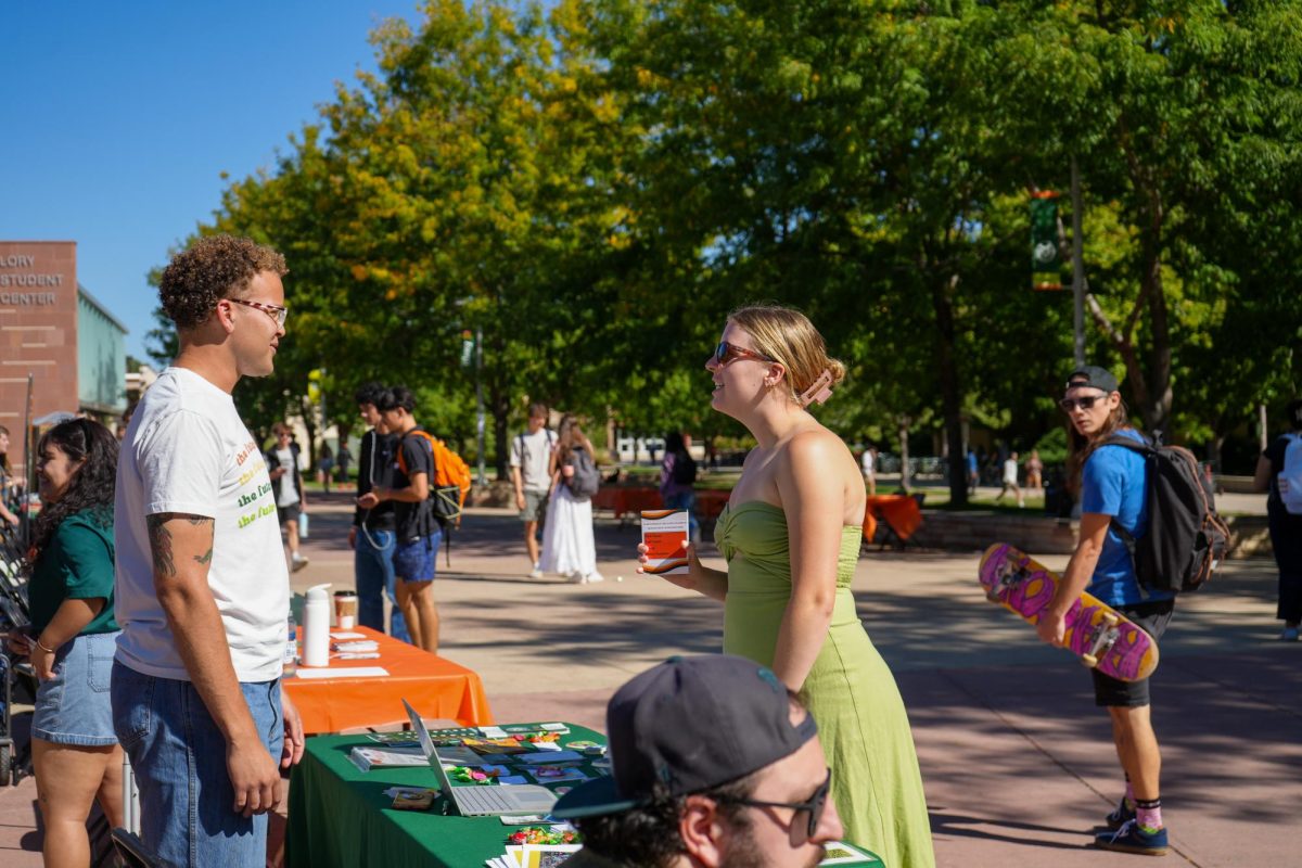 ASCSU Deputy Director of Basic Needs Lauren Johnson speaks with Alex Diggs, a representative of the Cultural Resource Centers and the Office of Inclusive Excellence during the Wellness Wonderland event on Sept. 20. Organizations could table with materials benefitting the wellbeing of students. 