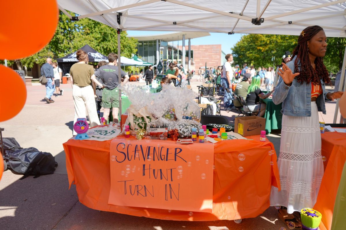 Associated Students of Colorado State University intern Evan Achebe directs participants in front of the scavenger hunt prize table at Wellness Wonderland. Including free resources from organizations around campus, the Wellness Wonderland featured a scavenger hunt raffle drawing. 