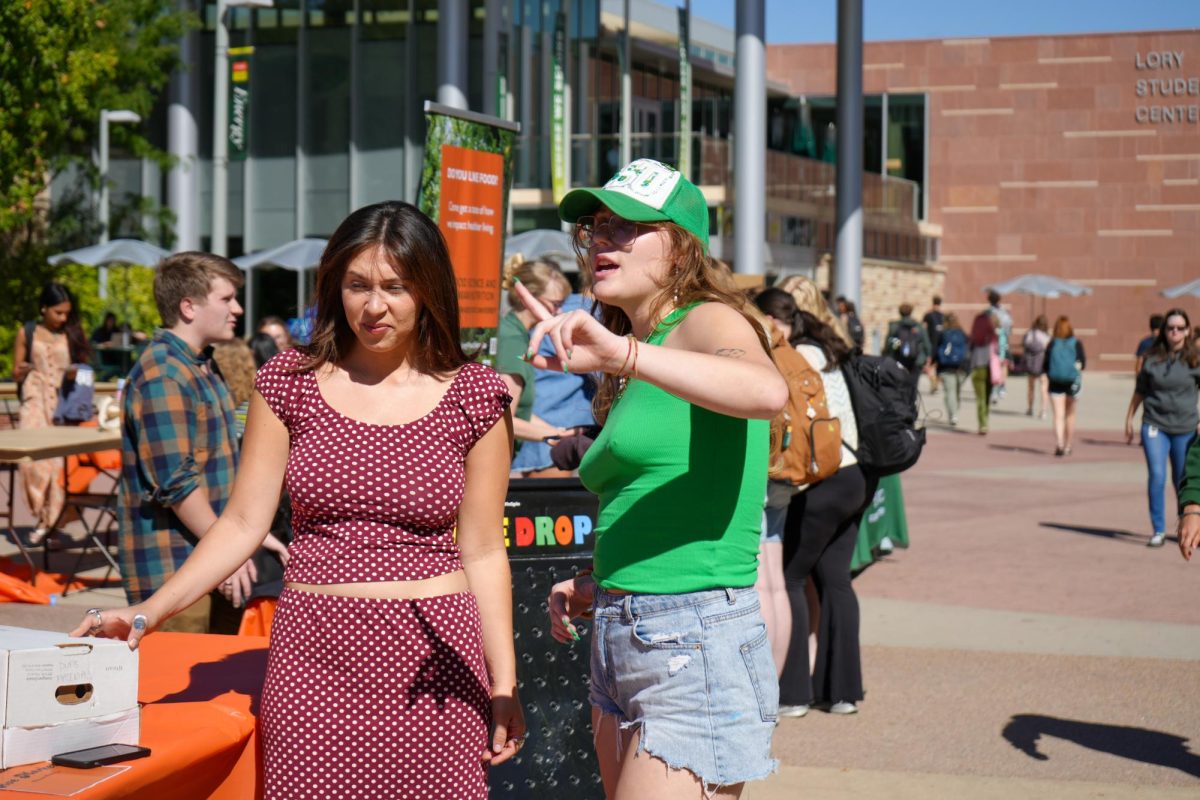 Associated Students of Colorado State University Director of Basic Needs Jorja Whyte speaks with a tabling representative during the Wellness Wonderland event on The Plaza Sept. 20. The event featured various campus organizations tabling to provide physical and mental wellbeing resources for students. 