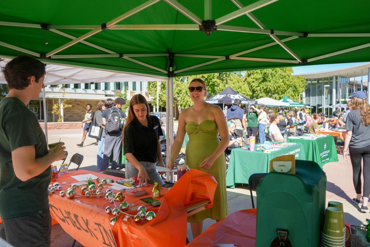 Associated Students of Colorado State University Deputy Director of Basic Needs Lauren Johnson and Director of Governmental Affairs Ava Wilkins set up the Wellness Wonderland check in table. The event was hosted on The Plaza on Sept. 20 by the Department of Basic Needs at ASCSU. 