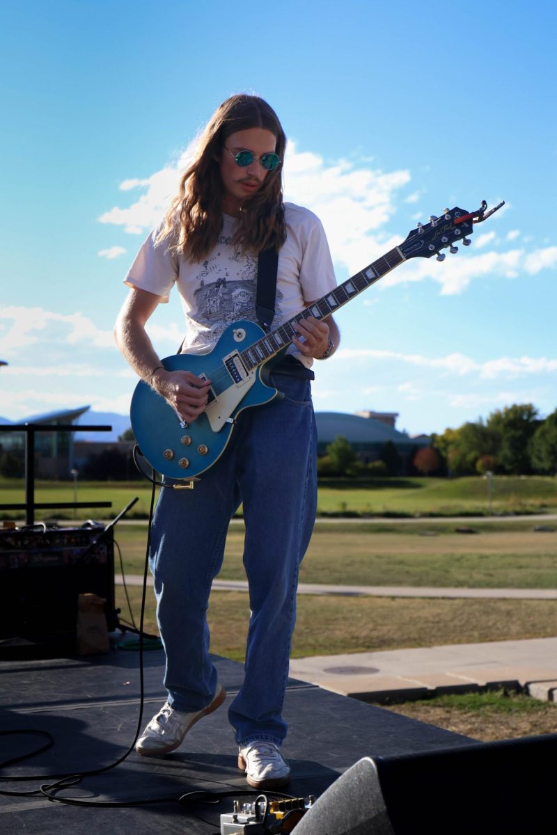 Josh Kates play guitar for local band, Heliotrope, during annual Battle of the Bands competition on Sept. 19. 