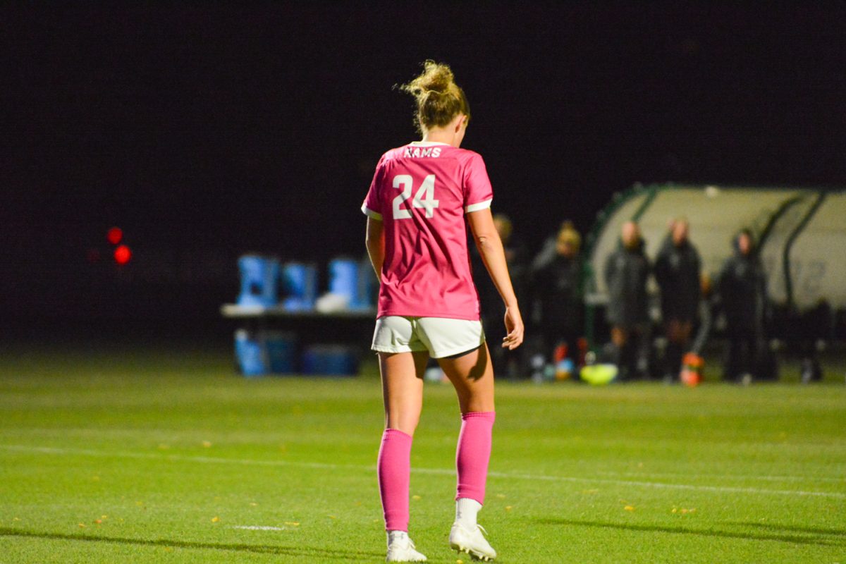 Girl in pink jersey walking