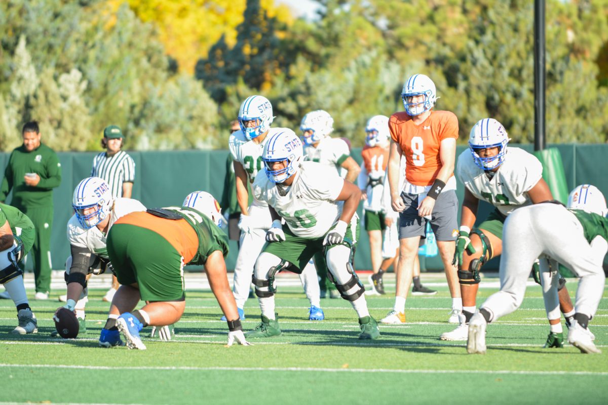 CSU football players practicing a play during morning practice. 