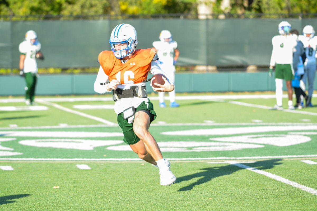 CSU quarterback running with the ball during morning practice. 